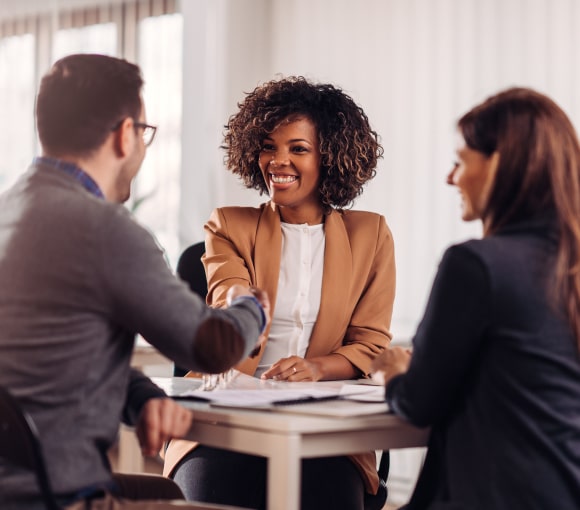 group of professionals shaking hands during employment mediation and conflict resolution